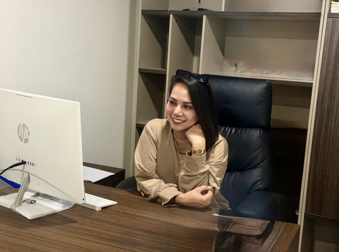 Maribel seated at her desk